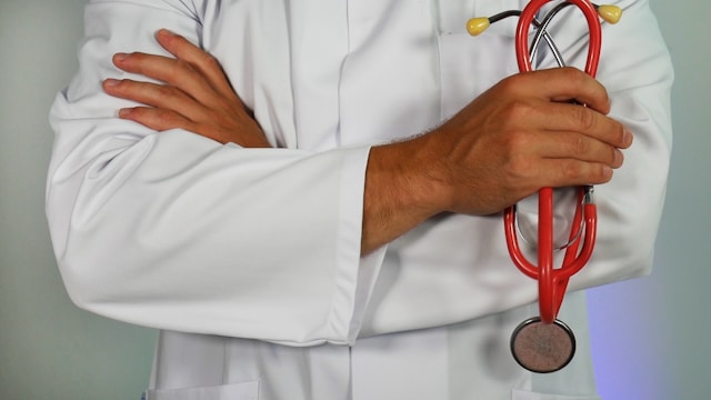 doctor in white coat with arms crossed